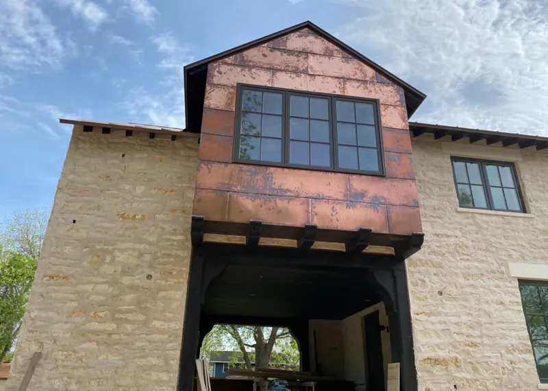 Copper metal panel facade on a stone building for Roof Repair in Carlsbad